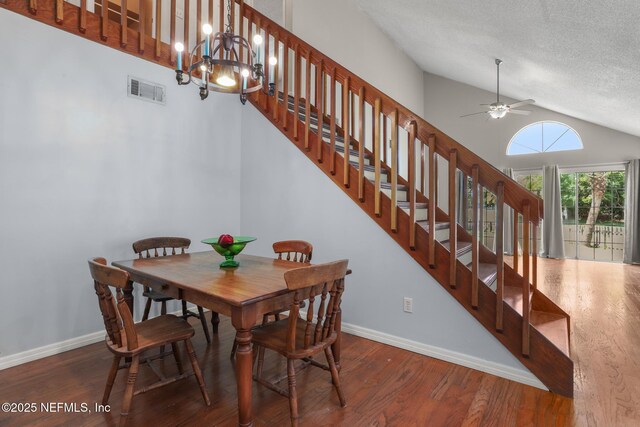 1430 Spindrift Cir E, Neptune Beach, FL 32266 - dining room featuring lofted ceiling, stairway, wood finished floors, a ceiling fan, and a textured ceiling