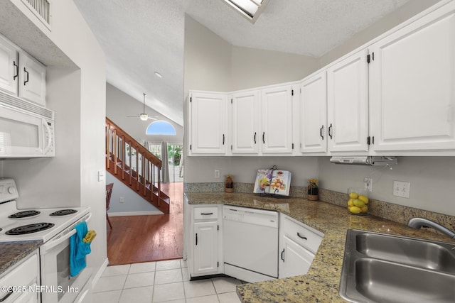 1430 Spindrift Cir E, Neptune Beach, FL 32266 - kitchen with white appliances, light tile patterned floors, white cabinets, a textured ceiling, and ceiling fan