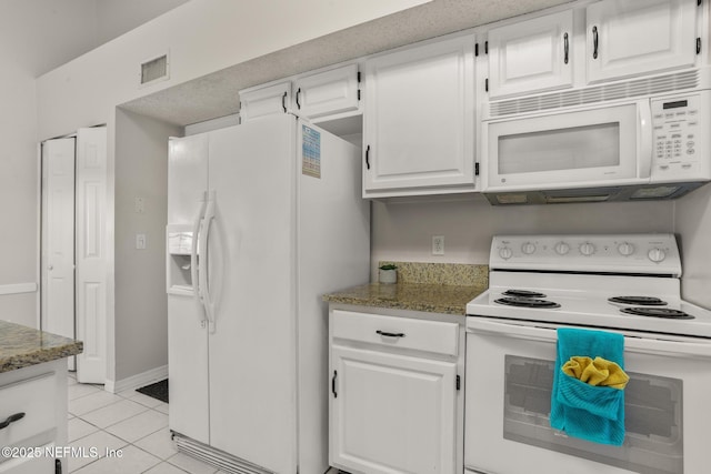 1430 Spindrift Cir E, Neptune Beach, FL 32266 - kitchen featuring white appliances, white cabinets, light tile patterned flooring, and light stone countertops