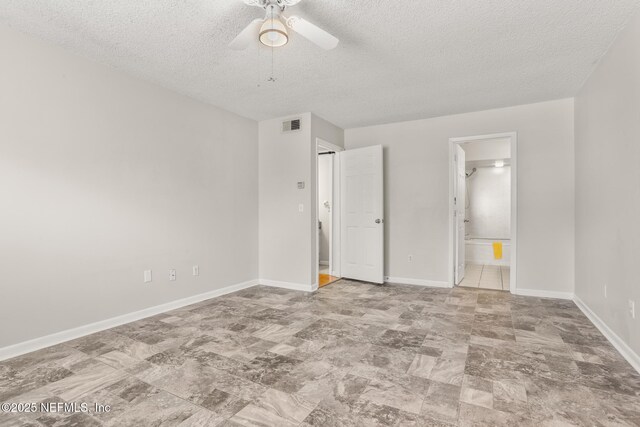 1430 Spindrift Cir E, Neptune Beach, FL 32266 - unfurnished bedroom with a textured ceiling, ensuite bath, and a ceiling fan
