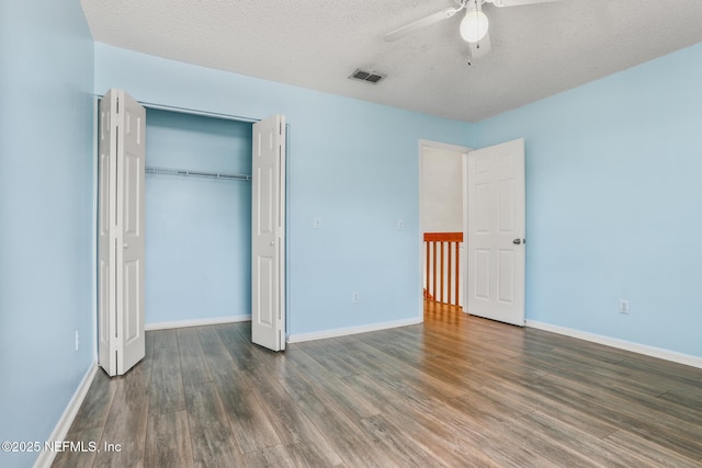 1430 Spindrift Cir E, Neptune Beach, FL 32266 - unfurnished bedroom featuring wood finished floors, a closet, ceiling fan, and a textured ceiling