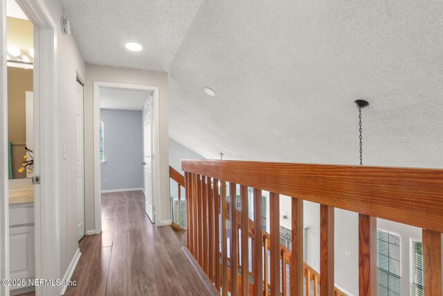 1430 Spindrift Cir E, Neptune Beach, FL 32266 - corridor with a textured ceiling, wood finished floors, an upstairs landing, and recessed lighting