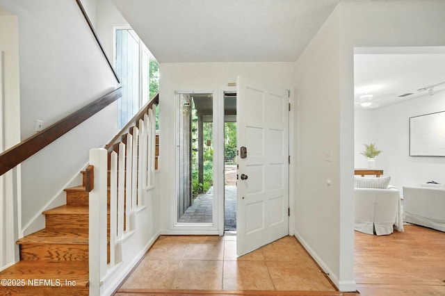 1918 Oak Cir, Atlantic Beach, FL 32233 - foyer with healthy amount of natural light, stairway, and light tile patterned floors