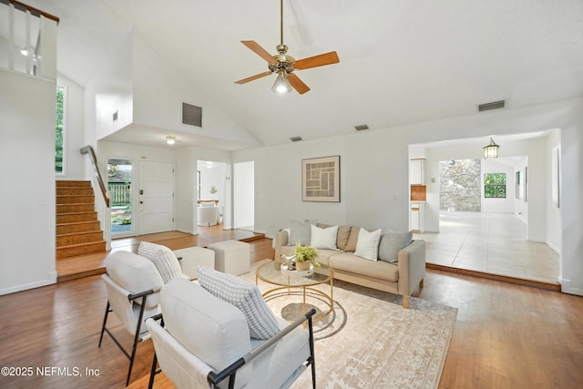 1918 Oak Cir, Atlantic Beach, FL 32233 - living area with high vaulted ceiling, light wood-style floors, stairs, and ceiling fan