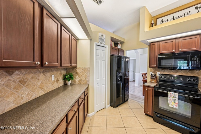 1400 Gibralter Ln, Fleming Island, FL 32003 - kitchen with black appliances, decorative backsplash, and light tile patterned floors