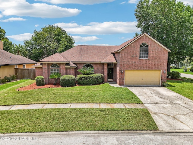 1400 Gibralter Ln, Fleming Island, FL 32003 - view of front facade with concrete driveway, brick siding, an attached garage, and roof with shingles