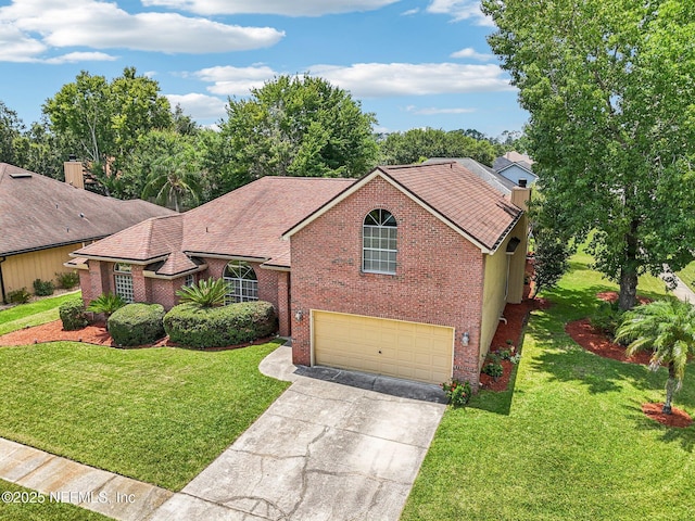 1400 Gibralter Ln, Fleming Island, FL 32003 - view of front of house featuring brick siding, concrete driveway, an attached garage, and a chimney
