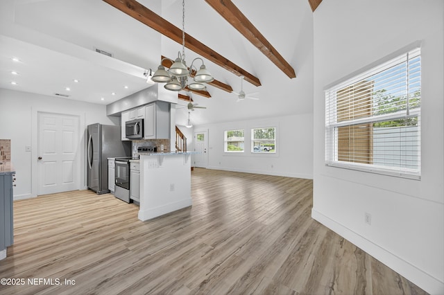 15 Katrina Pl, Palm Coast, FL 32164 - kitchen featuring stainless steel appliances, open floor plan, a chandelier, decorative backsplash, and beamed ceiling