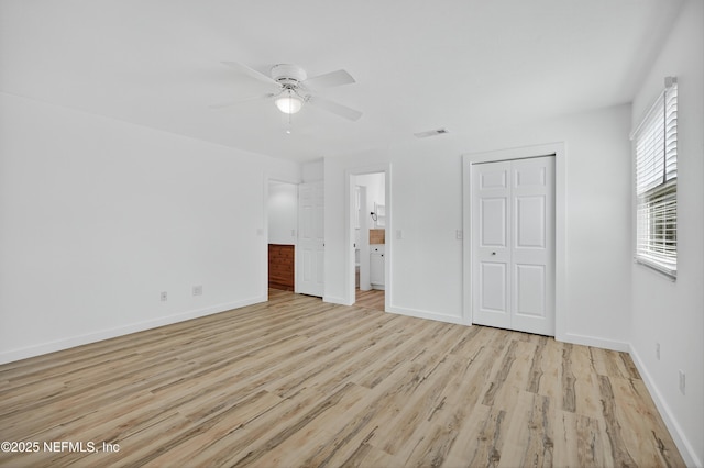 15 Katrina Pl, Palm Coast, FL 32164 - unfurnished bedroom featuring light wood-style floors, a closet, connected bathroom, and ceiling fan