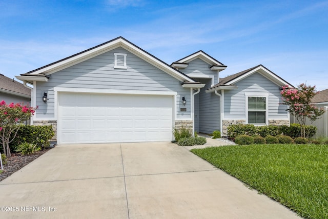 83316 Chapel Ct, Fernandina Beach, FL 32034 - view of front facade with stone siding, concrete driveway, a garage, and a front lawn