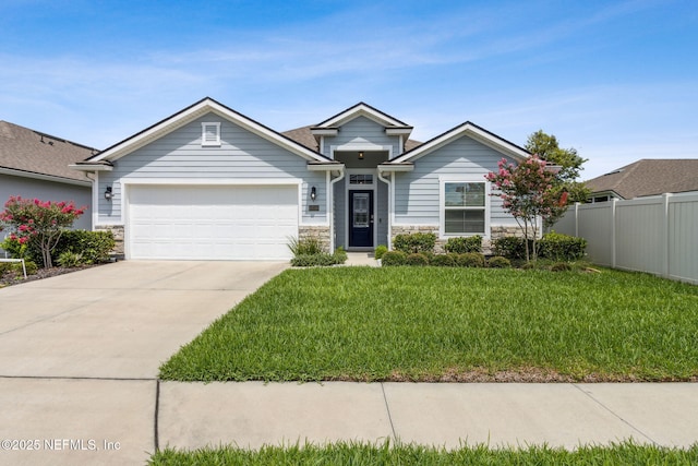 83316 Chapel Ct, Fernandina Beach, FL 32034 - view of front facade featuring stone siding, a garage, and driveway