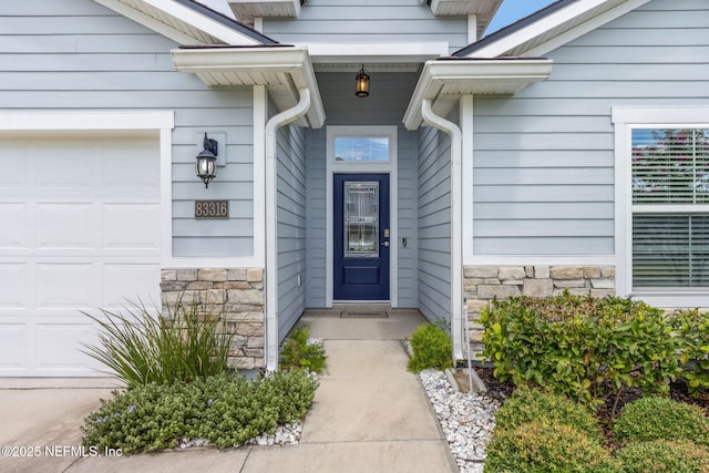 83316 Chapel Ct, Fernandina Beach, FL 32034 - entrance to property featuring stone siding and a garage