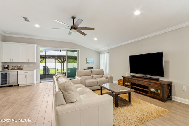 83316 Chapel Ct, Fernandina Beach, FL 32034 - living area featuring beverage cooler, light wood-style floors, a ceiling fan, ornamental molding, and lofted ceiling