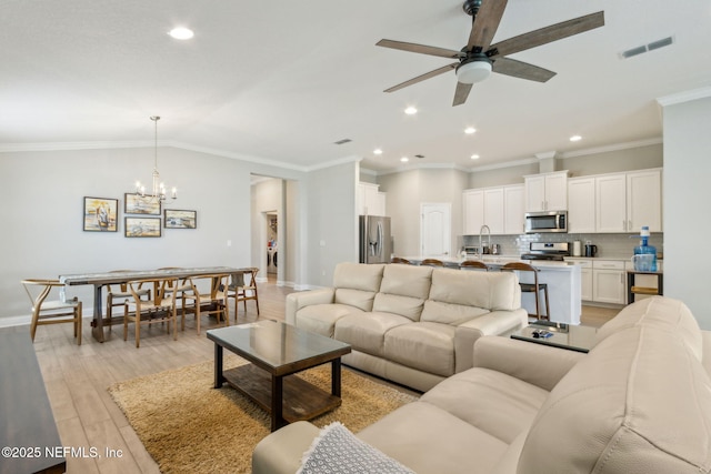 83316 Chapel Ct, Fernandina Beach, FL 32034 - living area with ceiling fan, light wood-type flooring, a chandelier, recessed lighting, and crown molding