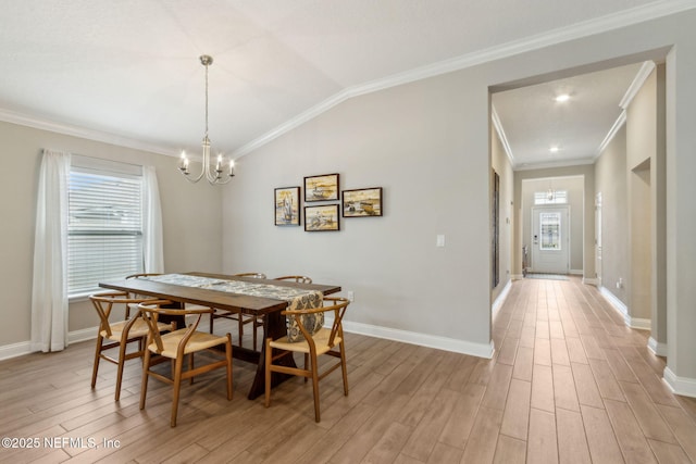 83316 Chapel Ct, Fernandina Beach, FL 32034 - dining space featuring a chandelier, light wood-style flooring, ornamental molding, and vaulted ceiling