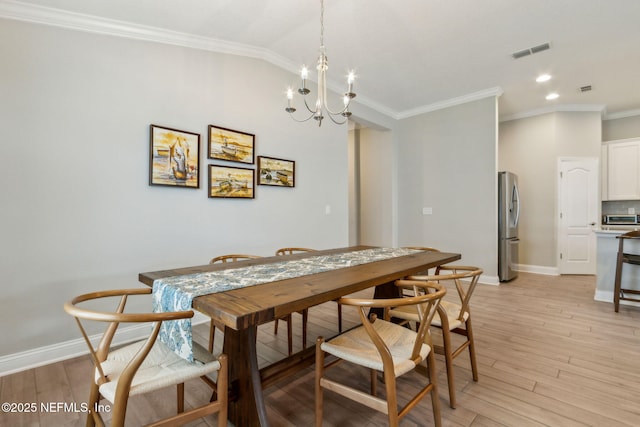 83316 Chapel Ct, Fernandina Beach, FL 32034 - dining space featuring a chandelier, crown molding, light wood finished floors, recessed lighting, and lofted ceiling