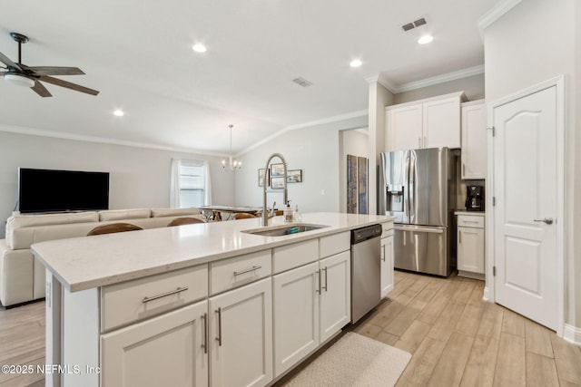 83316 Chapel Ct, Fernandina Beach, FL 32034 - kitchen with stainless steel appliances, crown molding, open floor plan, white cabinets, and ceiling fan