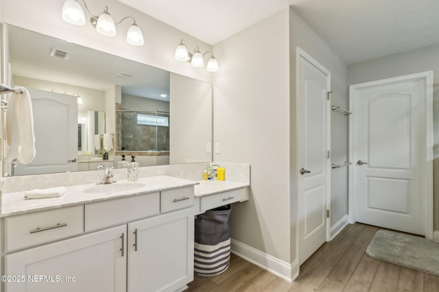 83316 Chapel Ct, Fernandina Beach, FL 32034 - bathroom with vanity, tiled shower, and wood finished floors