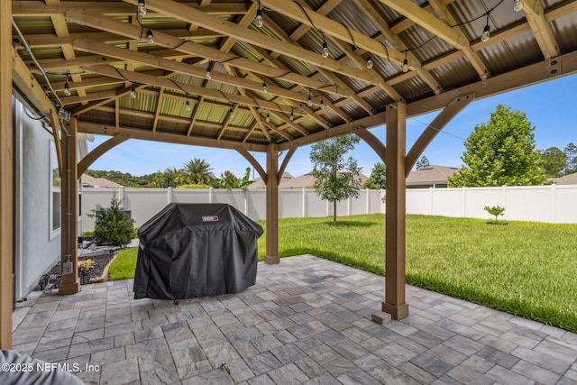 83316 Chapel Ct, Fernandina Beach, FL 32034 - fenced backyard featuring grilling area, a gazebo, and a patio area