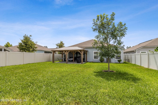 83316 Chapel Ct, Fernandina Beach, FL 32034 - rear view of property featuring a gazebo, a fenced backyard, and stucco siding