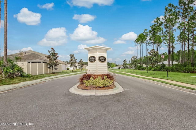 83316 Chapel Ct, Fernandina Beach, FL 32034 - view of asphalt street featuring sidewalks, curbs, and traffic signs