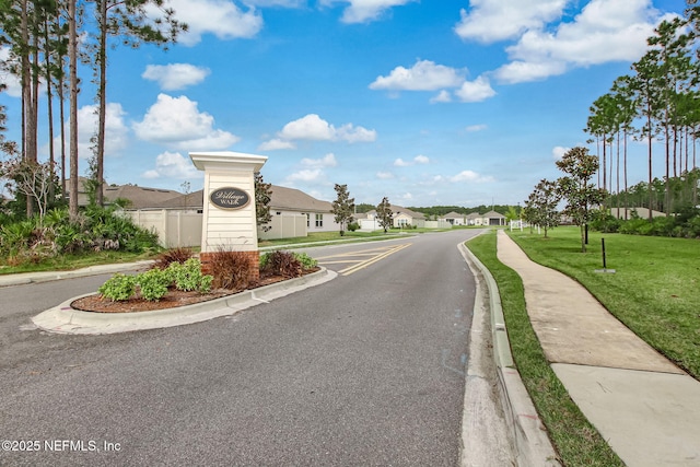 83316 Chapel Ct, Fernandina Beach, FL 32034 - view of asphalt road with a residential view, curbs, and sidewalks