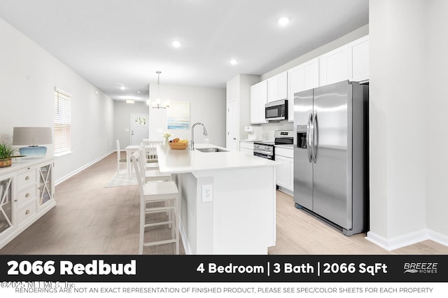 9018 Whinny Way Lot 276, Jacksonville, FL 32219 - kitchen with stainless steel appliances, light wood-style flooring, white cabinetry, recessed lighting, and a center island with sink