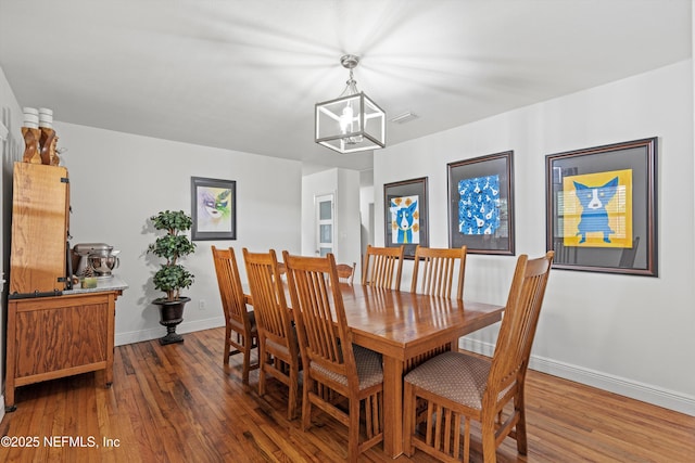 6241 Riviera Manor Dr, Jacksonville, FL 32216 - dining area featuring wood finished floors and a chandelier