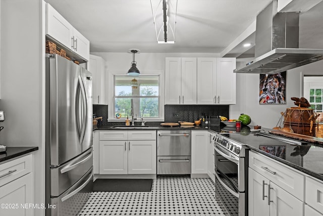 6241 Riviera Manor Dr, Jacksonville, FL 32216 - kitchen featuring stainless steel appliances, wall chimney range hood, white cabinetry, and decorative backsplash