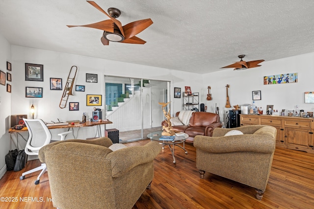 6241 Riviera Manor Dr, Jacksonville, FL 32216 - living room with ceiling fan, stairs, wood finished floors, and a textured ceiling