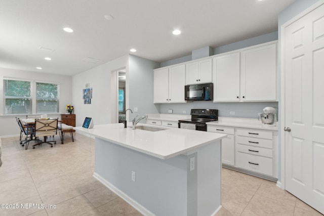 2972 Laurel Springs Dr, Green Cove Springs, FL 32043 - kitchen with black appliances, light tile patterned flooring, recessed lighting, and white cabinets