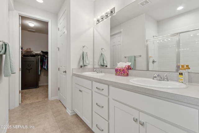 2972 Laurel Springs Dr, Green Cove Springs, FL 32043 - bathroom with double vanity, a stall shower, tile patterned floors, a spacious closet, and recessed lighting