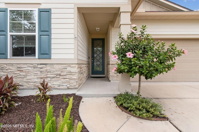 2972 Laurel Springs Dr, Green Cove Springs, FL 32043 - view of exterior entry with stone siding and an attached garage