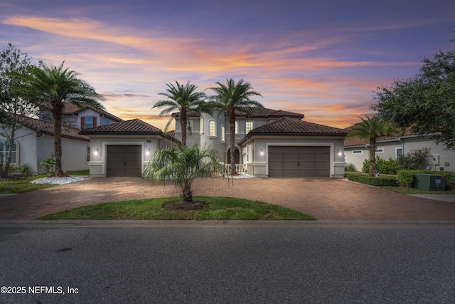2936 Brettungar Dr, Jacksonville, FL 32246 - mediterranean / spanish house featuring stucco siding, a garage, a tiled roof, and driveway