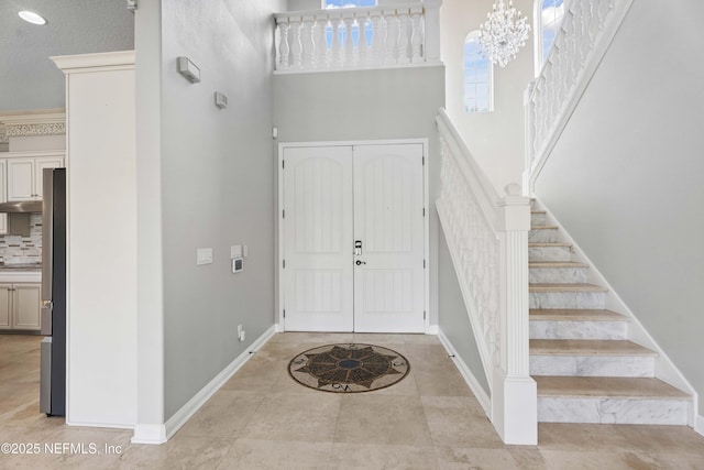 2936 Brettungar Dr, Jacksonville, FL 32246 - entrance foyer with a towering ceiling, stairway, and light tile patterned floors
