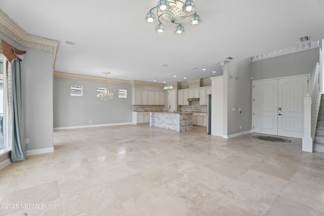 2936 Brettungar Dr, Jacksonville, FL 32246 - unfurnished living room with a chandelier, stairs, and ornamental molding