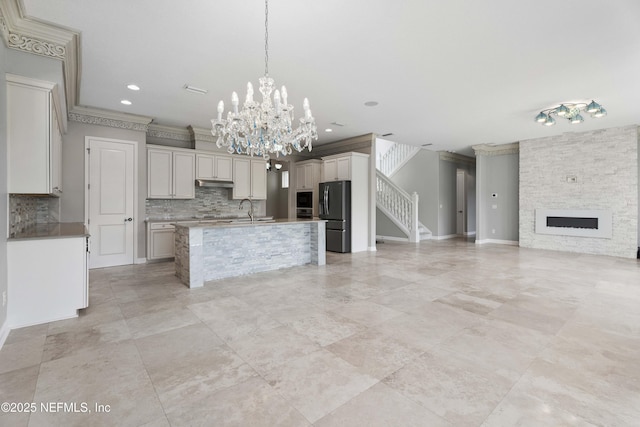 2936 Brettungar Dr, Jacksonville, FL 32246 - unfurnished living room with a chandelier, stairs, crown molding, recessed lighting, and a fireplace