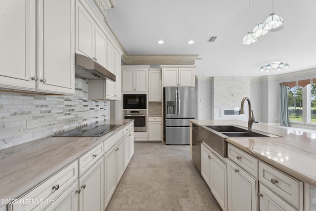 2936 Brettungar Dr, Jacksonville, FL 32246 - kitchen featuring black appliances, decorative backsplash, under cabinet range hood, light stone countertops, and crown molding