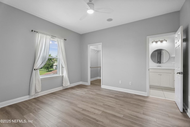 2936 Brettungar Dr, Jacksonville, FL 32246 - unfurnished bedroom featuring light wood finished floors, a spacious closet, connected bathroom, and ceiling fan