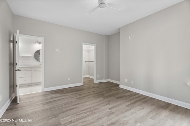 2936 Brettungar Dr, Jacksonville, FL 32246 - unfurnished bedroom with light wood-style floors, a spacious closet, ensuite bath, and ceiling fan