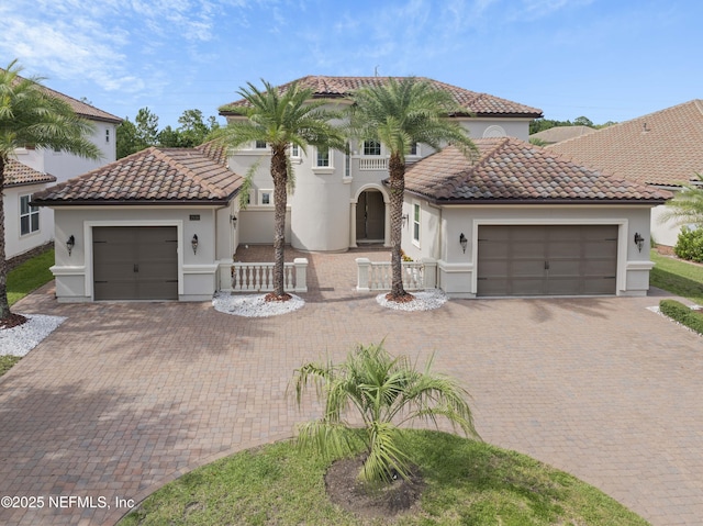 2936 Brettungar Dr, Jacksonville, FL 32246 - mediterranean / spanish home with a tiled roof, stucco siding, decorative driveway, and a garage