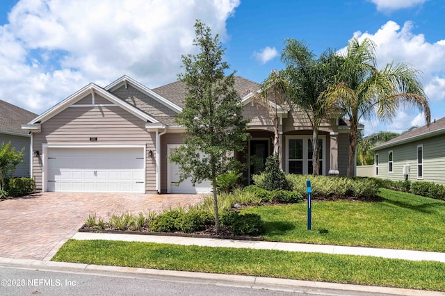 296 Latrobe Ave, Saint Augustine, FL 32095 - view of front facade featuring decorative driveway, an attached garage, and a front lawn