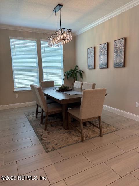 296 Latrobe Ave, Saint Augustine, FL 32095 - dining room with crown molding, a chandelier, and wood finish floors