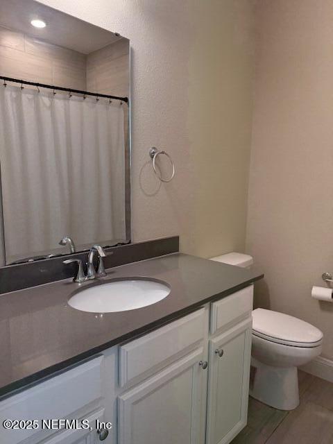 296 Latrobe Ave, Saint Augustine, FL 32095 - full bath with vanity, wood finished floors, and curtained shower
