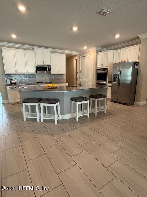 296 Latrobe Ave, Saint Augustine, FL 32095 - kitchen with appliances with stainless steel finishes, white cabinets, dark countertops, backsplash, and recessed lighting