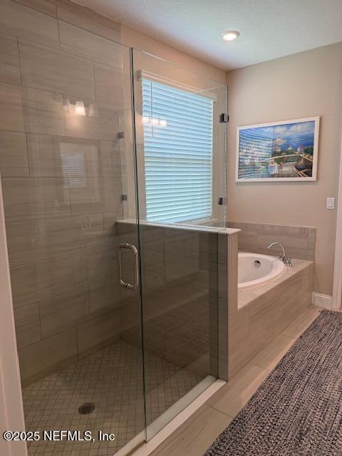 296 Latrobe Ave, Saint Augustine, FL 32095 - bathroom featuring tile patterned floors, a stall shower, and a garden tub