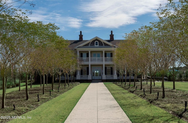 296 Latrobe Ave, Saint Augustine, FL 32095 - view of front of property with a balcony, a porch, french doors, and a chimney