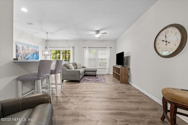 1515 Landau Rd, Jacksonville, FL 32225 - living area featuring wood finished floors, a textured ceiling, and ceiling fan