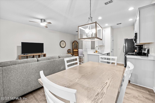 1515 Landau Rd, Jacksonville, FL 32225 - dining area featuring light wood finished floors, a ceiling fan, and recessed lighting