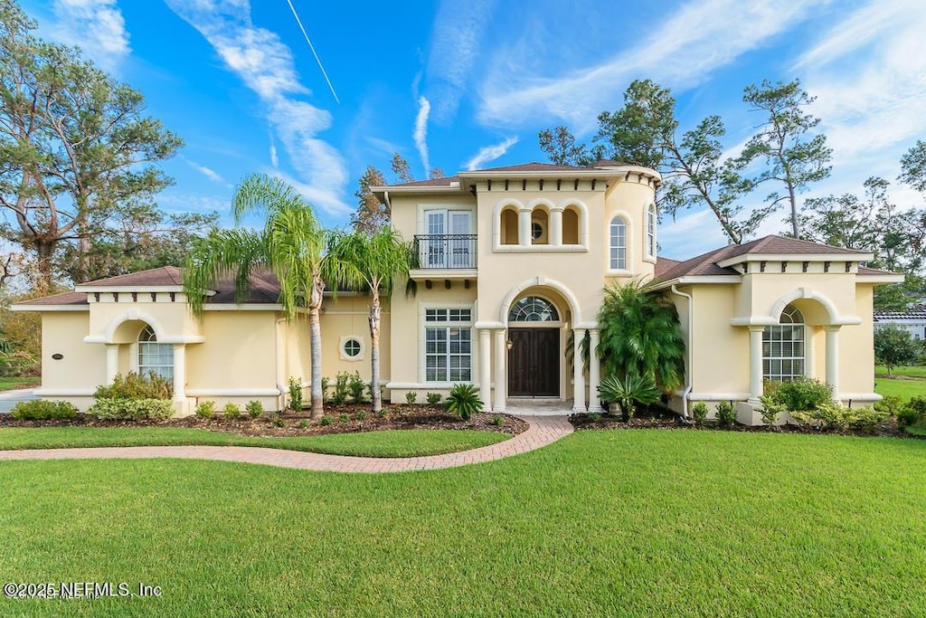 136 Strong Branch Dr, Ponte Vedra Beach, FL 32082 - mediterranean / spanish house featuring a balcony, stucco siding, and a front lawn